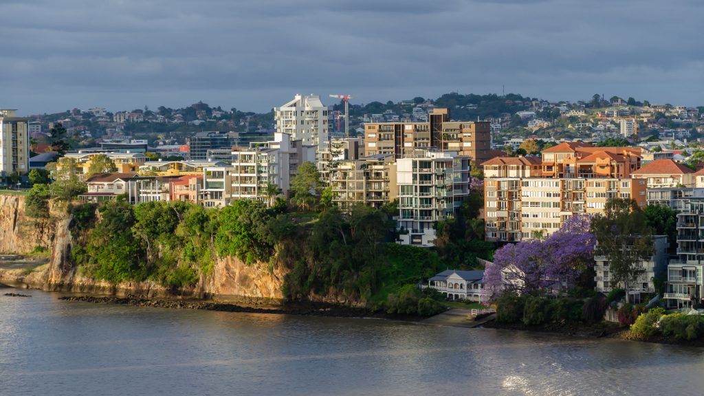 Brisbane apartments at sunset with the city in full bloom with jacaranda trees